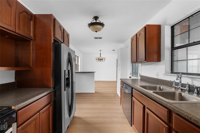 529 NE 12th Ct, Gainesville, FL 32601 - kitchen featuring stainless steel refrigerator with ice dispenser, a sink, dishwasher, a chandelier, and dark countertops