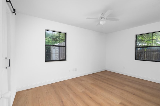 529 NE 12th Ct, Gainesville, FL 32601 - spare room featuring healthy amount of natural light, light wood-type flooring, baseboards, and a ceiling fan