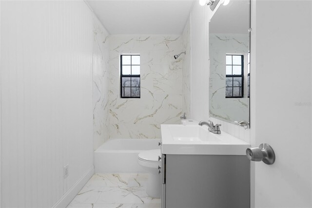 529 NE 12th Ct, Gainesville, FL 32601 - bathroom with toilet, vanity, marble look tile flooring, and tub / shower combination