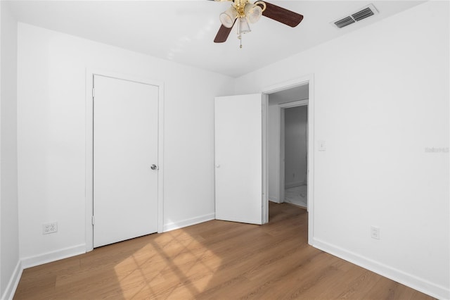 529 NE 12th Ct, Gainesville, FL 32601 - unfurnished bedroom with baseboards, wood finished floors, and ceiling fan