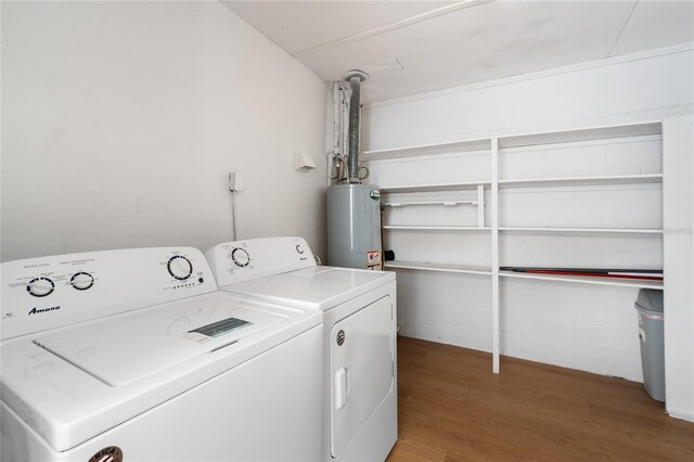 529 NE 12th Ct, Gainesville, FL 32601 - washroom with water heater, washer and dryer, and wood finished floors