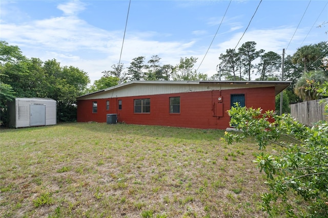 529 NE 12th Ct, Gainesville, FL 32601 - rear view of house with a storage shed, an outdoor structure, and cooling unit