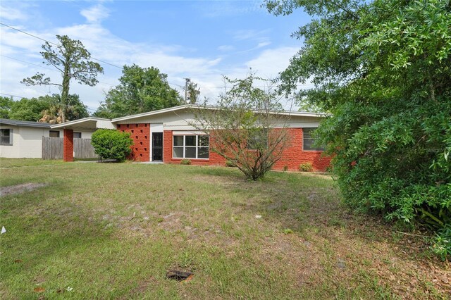 529 NE 12th Ct, Gainesville, FL 32601 - rear view of property with brick siding