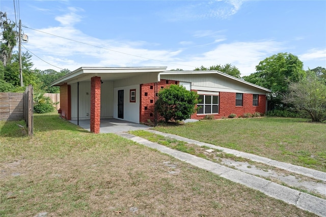 529 NE 12th Ct, Gainesville, FL 32601 - view of front of home featuring brick siding and a carport