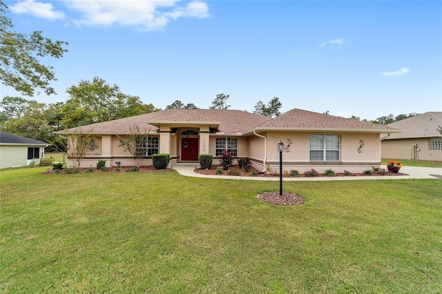 single story home with a front yard and stucco siding