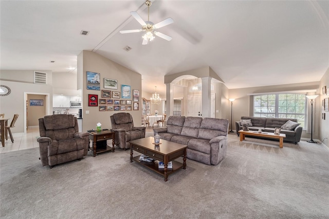 carpeted living room with ceiling fan with notable chandelier, ornate columns, and visible vents