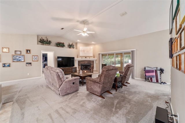 carpeted living room with a ceiling fan, visible vents, a tile fireplace, baseboards, and lofted ceiling