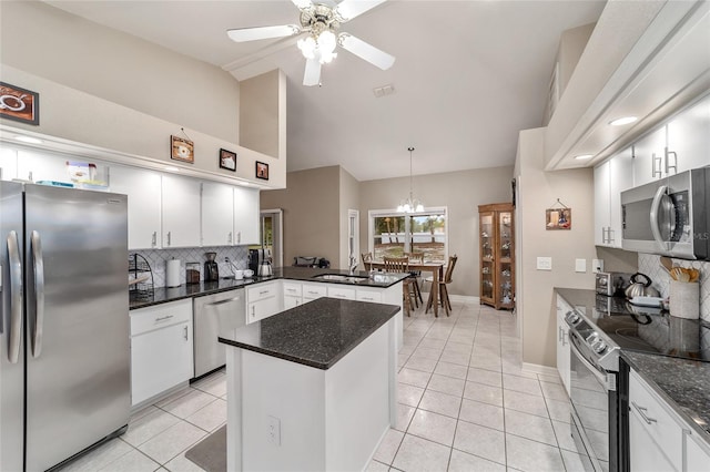 kitchen with decorative backsplash, a sink, high vaulted ceiling, light tile patterned floors, and stainless steel appliances