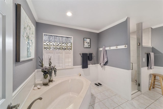 bathroom with a garden tub, crown molding, wainscoting, tile patterned floors, and a shower stall