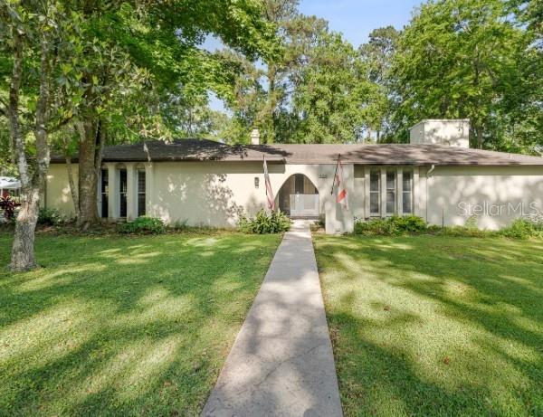 view of front facade with stucco siding and a front lawn