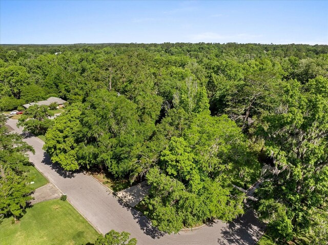 drone / aerial view with a wooded view