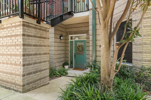 339 NE 2nd Ave, Gainesville, FL 32601 - doorway to property featuring brick siding and a balcony