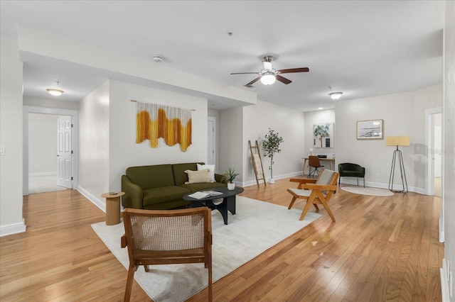 339 NE 2nd Ave, Gainesville, FL 32601 - living area featuring light wood-type flooring, baseboards, and ceiling fan