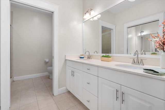 339 NE 2nd Ave, Gainesville, FL 32601 - bathroom featuring a sink, baseboards, tile patterned flooring, and toilet