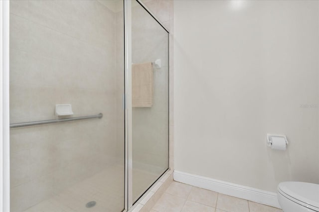 339 NE 2nd Ave, Gainesville, FL 32601 - full bath with toilet, tile patterned floors, baseboards, and a stall shower