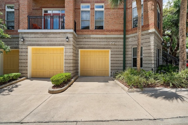 339 NE 2nd Ave, Gainesville, FL 32601 - view of front of property with an attached garage, driveway, and brick siding