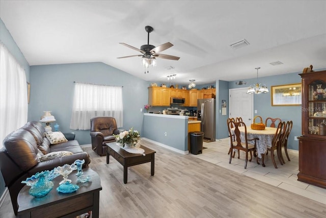 living area with visible vents, light wood-style flooring, lofted ceiling, and ceiling fan with notable chandelier