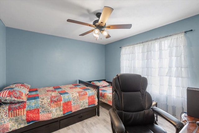 bedroom with wood finished floors and a ceiling fan