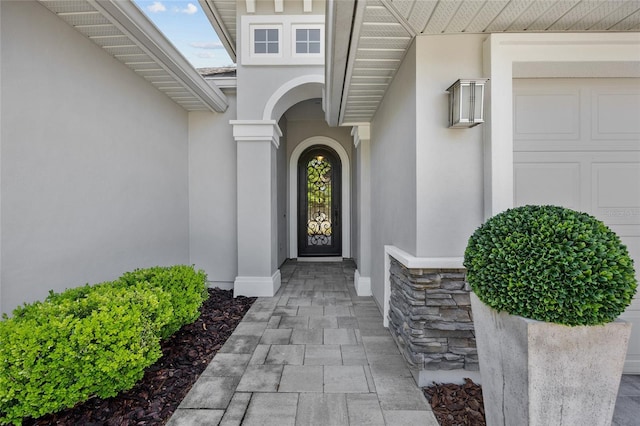 555 NW 134th Way, Newberry, FL 32669 - doorway to property with an attached garage, stucco siding, and stone siding
