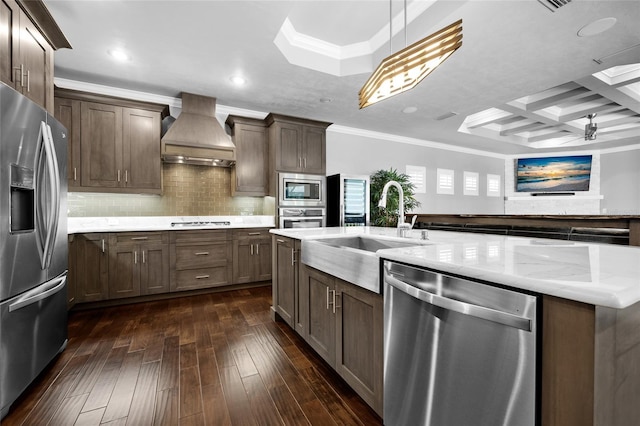 555 NW 134th Way, Newberry, FL 32669 - kitchen with crown molding, appliances with stainless steel finishes, hanging light fixtures, custom range hood, and dark wood-type flooring