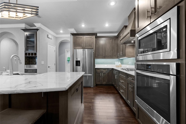 555 NW 134th Way, Newberry, FL 32669 - kitchen featuring ornamental molding, recessed lighting, dark wood-type flooring, arched walkways, and stainless steel appliances