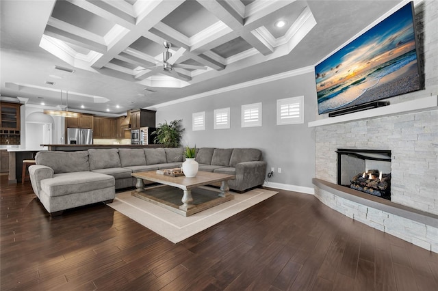 555 NW 134th Way, Newberry, FL 32669 - living room featuring beam ceiling, baseboards, a stone fireplace, ceiling fan, and dark wood finished floors