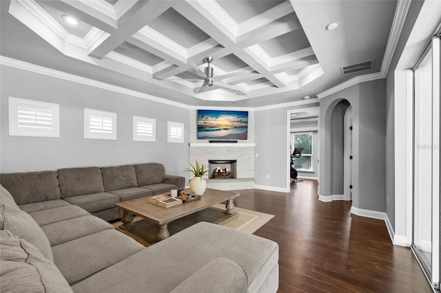 555 NW 134th Way, Newberry, FL 32669 - living room featuring arched walkways, a fireplace with raised hearth, a ceiling fan, visible vents, and dark wood-style floors