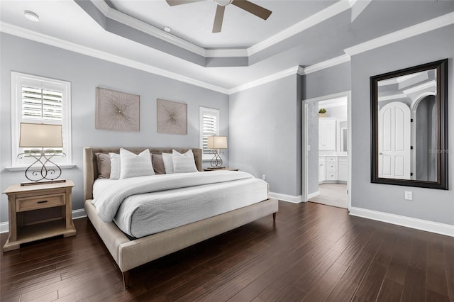 555 NW 134th Way, Newberry, FL 32669 - bedroom with dark wood-type flooring, baseboards, a tray ceiling, and multiple windows