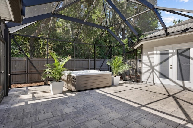 555 NW 134th Way, Newberry, FL 32669 - view of patio featuring a hot tub, a lanai, a fenced backyard, and french doors
