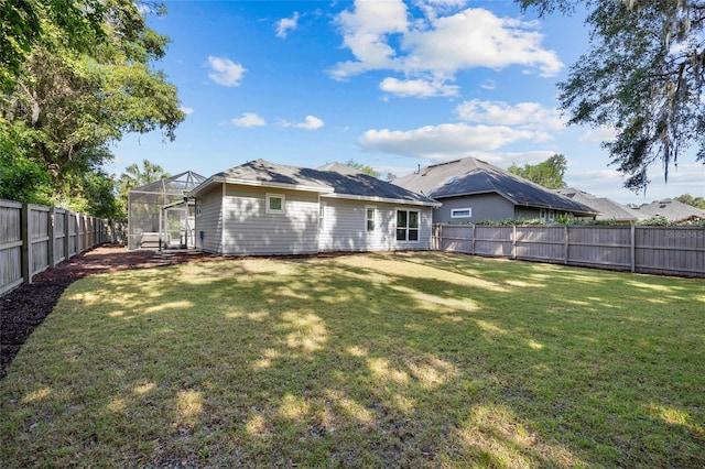 555 NW 134th Way, Newberry, FL 32669 - rear view of house featuring a fenced backyard, a lanai, and a lawn
