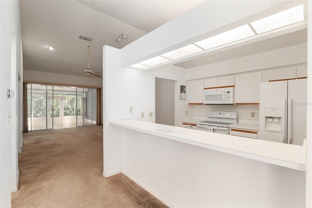 1020 NW 124th Dr, Newberry, FL 32669 - kitchen with white appliances, carpet floors, ceiling fan, and a peninsula