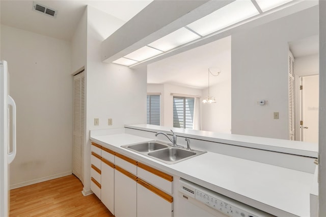 1020 NW 124th Dr, Newberry, FL 32669 - kitchen with a sink, light wood-type flooring, light countertops, dishwasher, and refrigerator