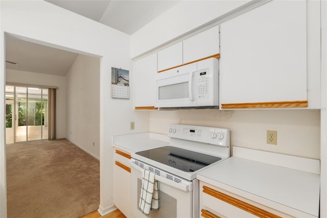 1020 NW 124th Dr, Newberry, FL 32669 - kitchen with white appliances, light countertops, white cabinetry, baseboards, and light colored carpet