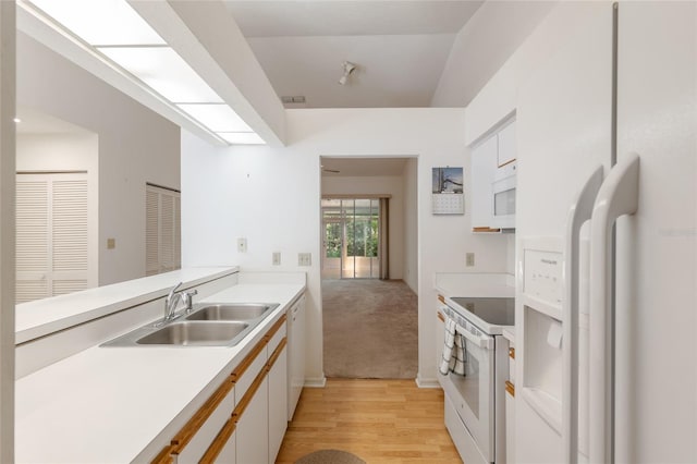 1020 NW 124th Dr, Newberry, FL 32669 - kitchen with white appliances, a sink, light wood-type flooring, light countertops, and white cabinetry