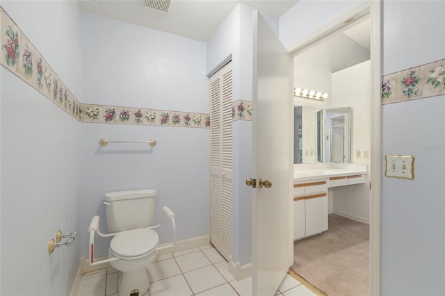 1020 NW 124th Dr, Newberry, FL 32669 - bathroom featuring toilet, vanity, tile patterned flooring, and baseboards