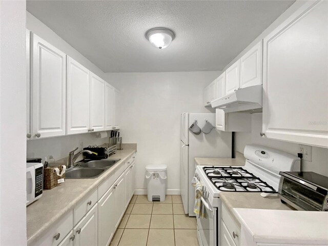 kitchen with a sink, white appliances, light countertops, white cabinetry, and under cabinet range hood