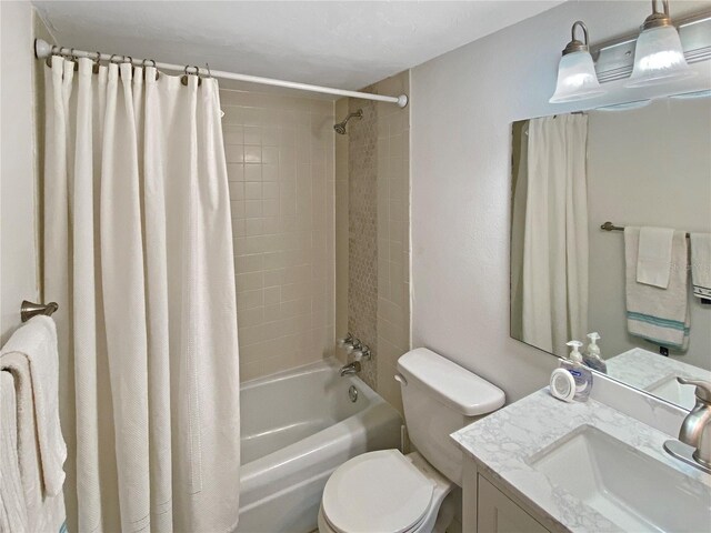 full bathroom featuring vanity, shower / bathtub combination with curtain, and toilet