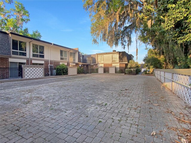 view of road featuring decorative driveway