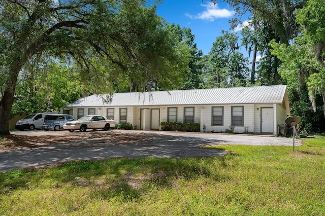 single story home featuring metal roof