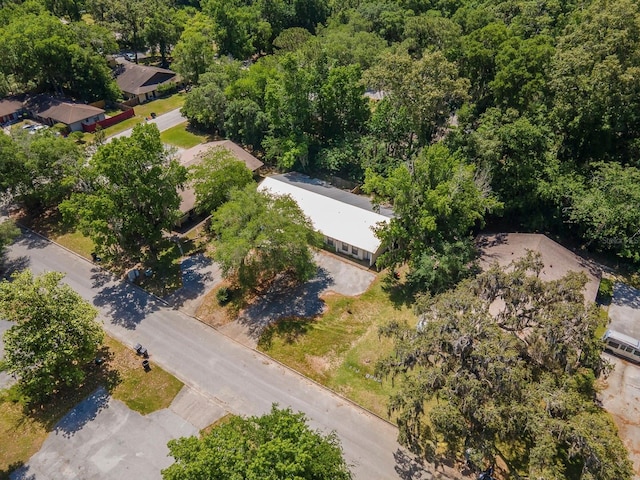 aerial view of property's location featuring a forest