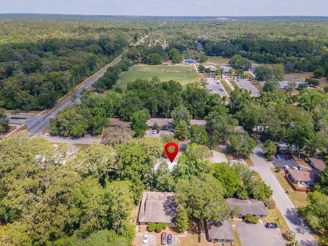 aerial view of property and surrounding area featuring a forest