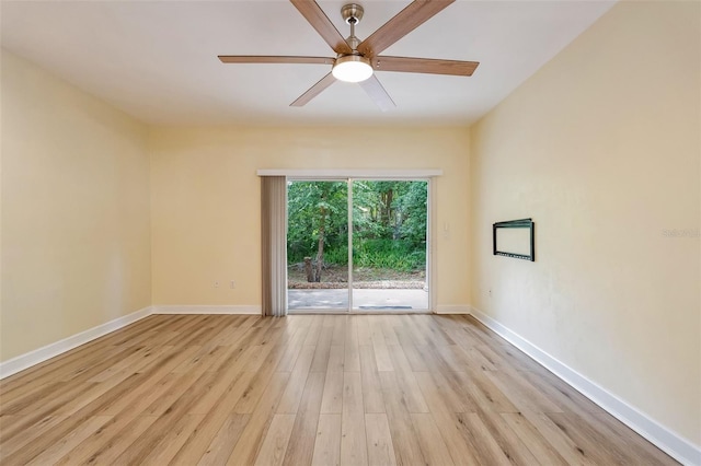 unfurnished room with a ceiling fan, baseboards, and light wood-style floors