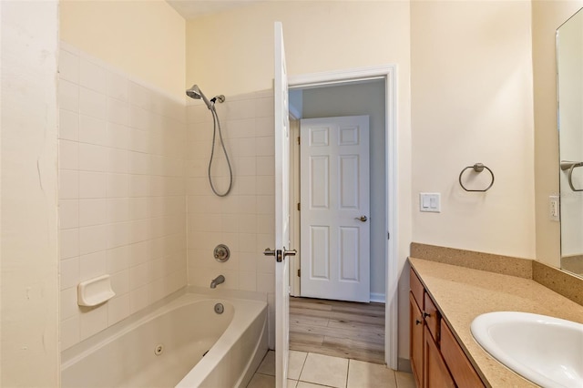 bathroom featuring vanity, tile patterned flooring, and a combined bath / shower with jetted tub