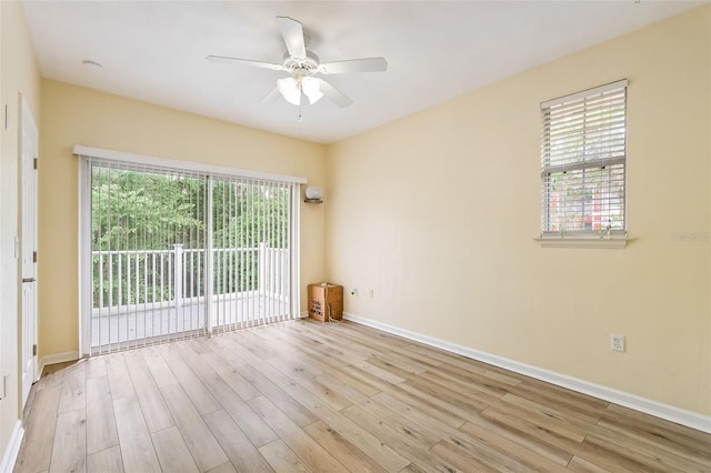 empty room featuring a ceiling fan, baseboards, and wood finished floors