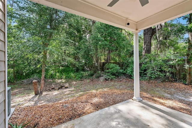 view of yard with fence, ceiling fan, and a patio area