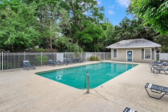 pool with fence and a patio