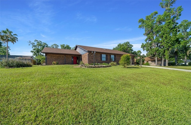 ranch-style house with brick siding and a front lawn