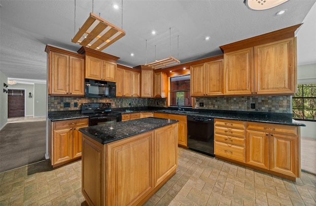 kitchen featuring a sink, a center island, dark stone counters, decorative backsplash, and black appliances