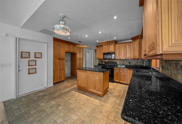 kitchen with brick patterned floor, a sink, black appliances, and tasteful backsplash