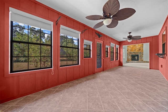 interior space with ceiling fan